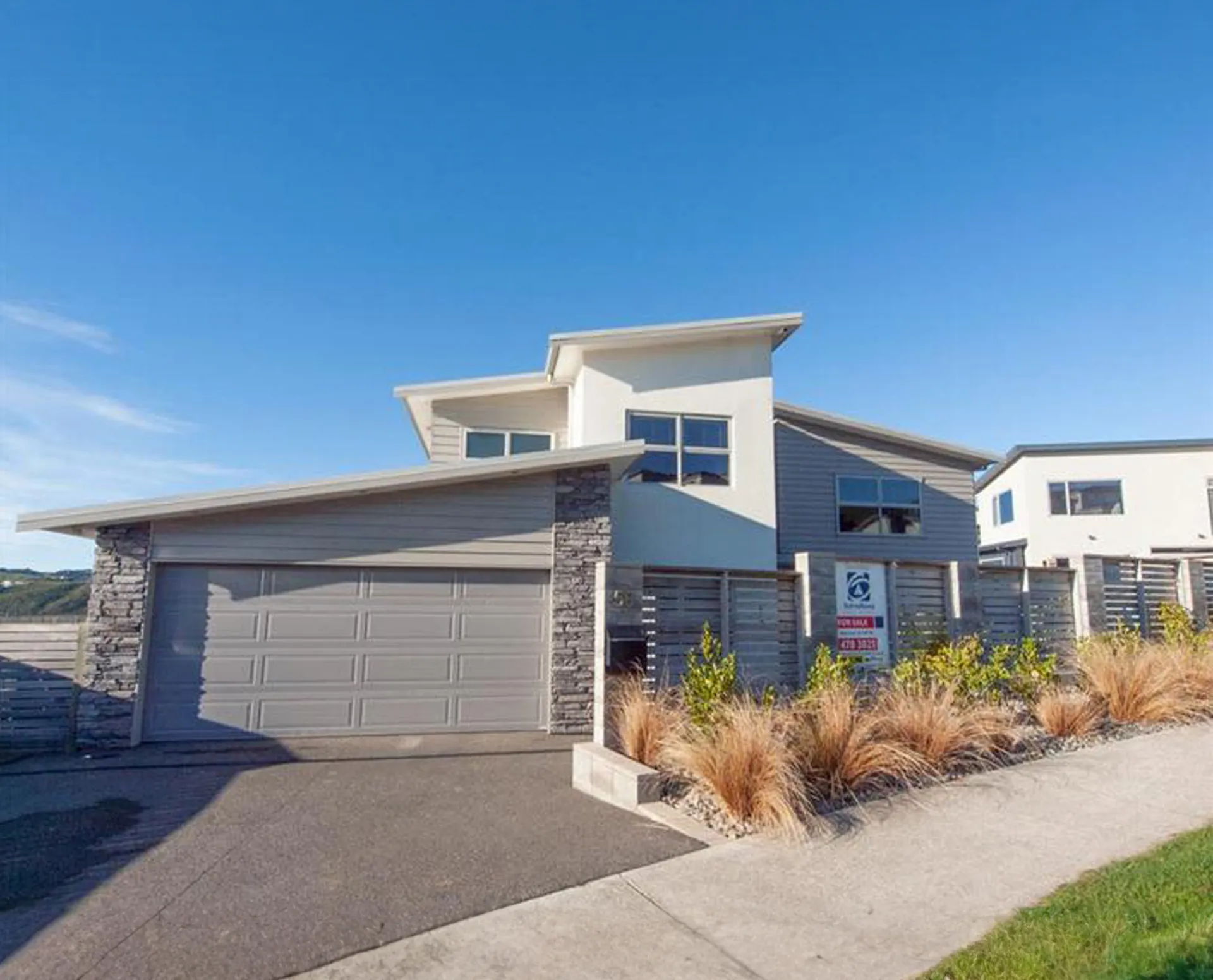 Modern residential new build by Trust Builders in greater Wellington — two-storey timber and stone-clad family home